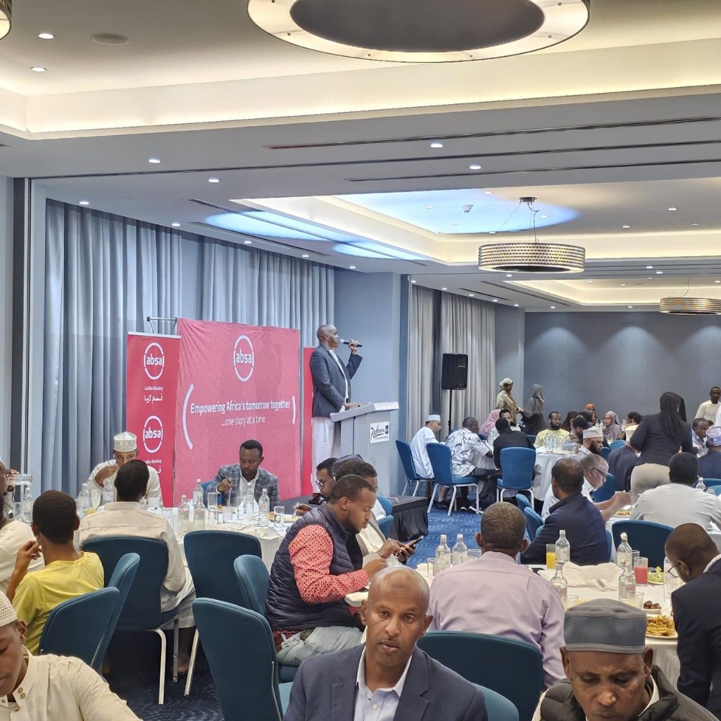 Wide view of Abdi Ahmed speaking at an Absa-sponsored ballroom dinner