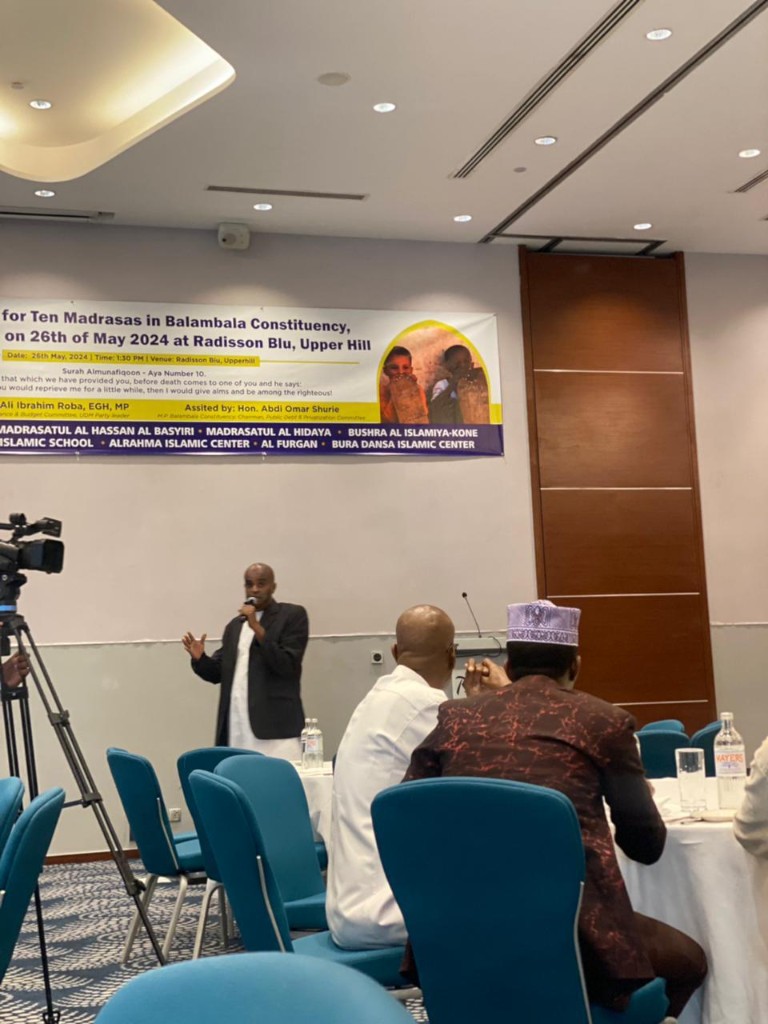 Abdi Ahmed speaking at the Balambala Madrasas fundraiser with a camera in the foreground